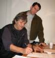 Michael Shelley and Doc Cavalier sign the papers. The Wildweeds shall be released!